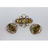 A pair of 9ct gold and citrine earrings, clip on, stamped 9ct, together with a brooch of similar