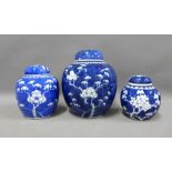 Three blue and white Prunus pattern ginger jars with covers, tallest 19cm (3)