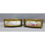 A pair of Sevres porcelain bowls, ormolu mounted, royal blue ground and with handpainted flowers, on