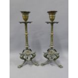 A pair of 19th century bronze and brass candlesticks, with detachable sconce and circular drip