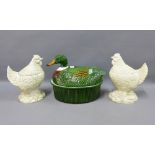 A duck tureen and cover and a pair of hen pottery storage jars with covers, (3) 27cm high