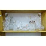 A collection of crystal and glass wares to include decanters with stoppers, biscuit barrel,