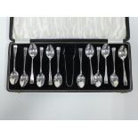 George V set of twelve silver teaspoons and matching sugar tongs, Birmingham 1930, in fitted case (