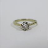 Solitaire diamond ring, claw set with a single old round cut diamond to a plain white metal band,