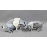 Raku glazed Saddleback Sow, modelled sitting, 23cm long, together with a smaller pig, signed