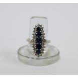 18ct white gold sapphire and diamond dress ring with a row of five graduated sapphires within a