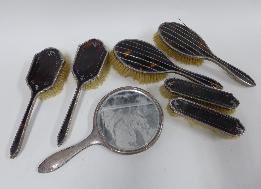 Silver and tortoiseshell backed brush sets (7)