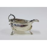 George III silver sauce boat, William Skeen, London 1767, with leaf capped flying scroll handle,