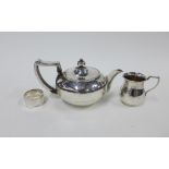 Georgian silver teapot, London 1807, George V silver cream jug , London 1921 and a silver napkin