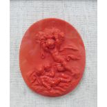 Red wax plaque of cherubs playing, framed with a glazed show frame, James McClure label verso,