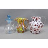Two coloured glass jugs and a small decanter and stopper, (3)