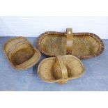 Vietnamese basket and two smaller baskets, all with a central looping handle, longest 95cm (3)