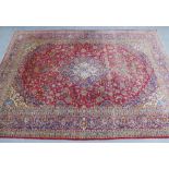 Persian style carpet, red field with central medallion and allover foliate pattern with multiple
