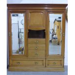 Mahogany wardrobe, moulded cornice with dentil frieze over a central cupboard with alcove, flanked