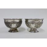 A pair of Edwardian silver pedestal bowls, with repoussé acanthus leaf decoration, Sheffield 1904,