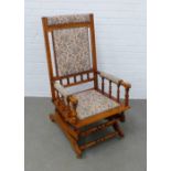 Mahogany and floral upholstered American rocking chair, 56 x 106 x 47cm