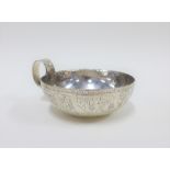 Silver single handled bowl with engraved Assyrian style border, hallmarks for Chester 1907, 15cm