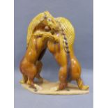 Tang style pottery figure of two rearing horses, amber glazed, on a shaped base, 40cm