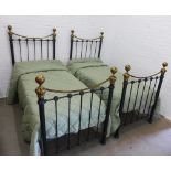 Pair of single beds and mattresses with ebonised metal and faux brass headboards, to include two