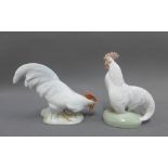 Two Royal Copenhagen porcelain Cockerels comprising 'Cock head down' No. 1127 and 'Cock head up' No.