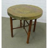 Eastern brass topped table, with dragon pattern, on a wooden base, 57 x 68cm