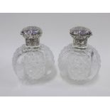 A pair of William Comyns silver topped glass scent bottles, London 1892, globular hob nail cut,