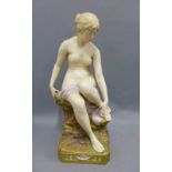 Royal Dux female nude figure, modelled seated on a naturalistic base, blush ivory glaze with