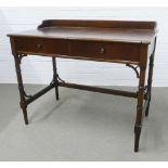 Mahogany ledgeback desk, with two drawers, raised on faux bamboo legs, 85 x 102 x 58cm