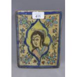 Qajar pottery tile of a youth, 15.5 x 20cm