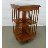 Modern revolving bookcase, the top with inlaid paterae, 86 x 46cm