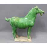 Tang style pottery horse, green glazed with rectangular base, 36cm