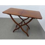 Mahogany campaign table on an x frame with turned stretchers,