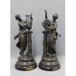 After Moreau, a pair of bronze patinated spelter figures, on circular bases, 58cm (2)