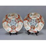 A pair of famille verte chargers, with scalloped rims, painted with birds and foliage, with