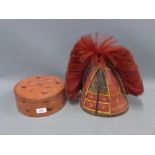 Red lacquered circular box, together with a red basket weave hat with plume (2)