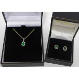 9ct gold emerald and diamond pendant on a yellow metal chain together with a pair of matching