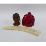 Faux amber Buddha, 11cm, and a fruitwood figure together with a modern faux ivory cribbage board (3)