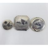 Two Eastern white metal and niello powder compacts and a similar trinket box (3)