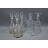 set of three triple ring neck decanters and stoppers together with a pair of glass decanters with