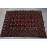 Bokhara rug, red field with four rows of eight guls, 250 x 182cm