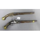 Two Eastern flintlock percussion pistols, a near pair, 48.5cm overall, (a/f with losses) (2)