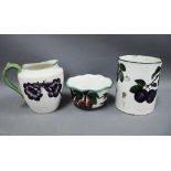 Wemyss ware pottery to include a jug with pansies pattern, bowl with plums and a tankard (handle