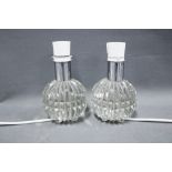 A pair of glass table lamps of small size, with facet cut bases, 13cm excluding fittings (2)