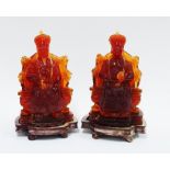 Pair of Chinese amber style Emperor figures, with wooden bases (2) 17 x 11cm