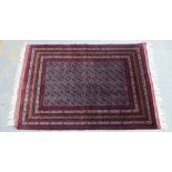 Tekke type rug, red and pale blue field with allover guls pattern within multiple borders, 155 x