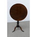 Mahogany tilt top table, circular top and baluster column with tripod legs and pad feet, 70 x 59cm