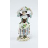 Meissen figure of a girl with a bundle of flowers on her head, blue crossed swords mark, 14cm