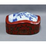Chinese red and black lacquered box with blue and white porcelain cover. 19 x 14cm