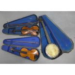 Vintage banjo and two violins, all with hard cases (3)