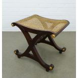 Mahogany x framed stool with canework sesat and gilt roundels. 52 x 46 x 40 cm